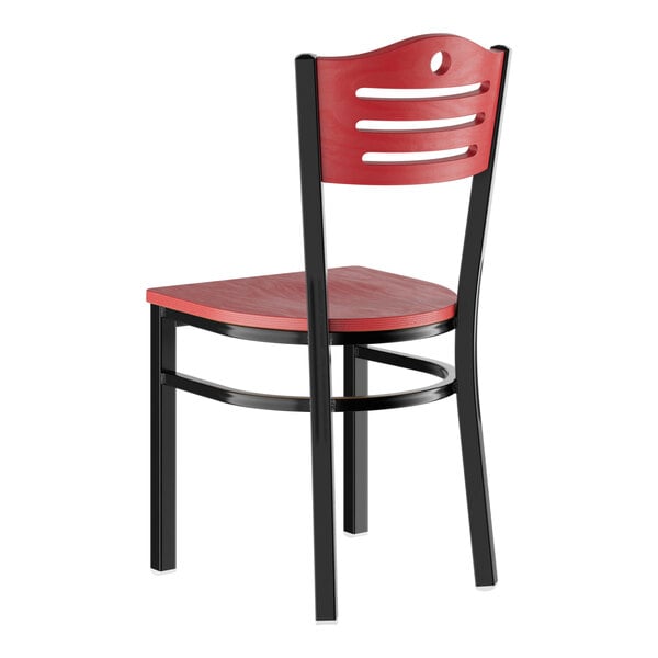 A standard height dining chair with a mahogany wood seat and backrest, featuring a black metal frame.