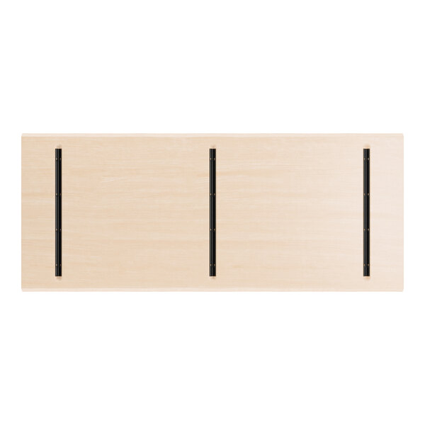 A rectangular, light wood table top with three parallel black metal strips running lengthwise.