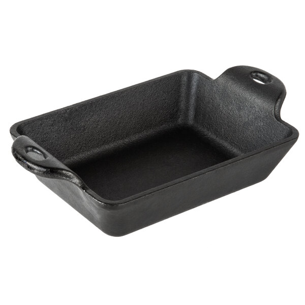 A black rectangular cast iron pan with handles.
