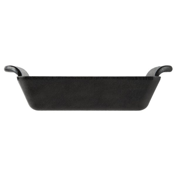 A black Lodge rectangular cast iron casserole dish with handles.
