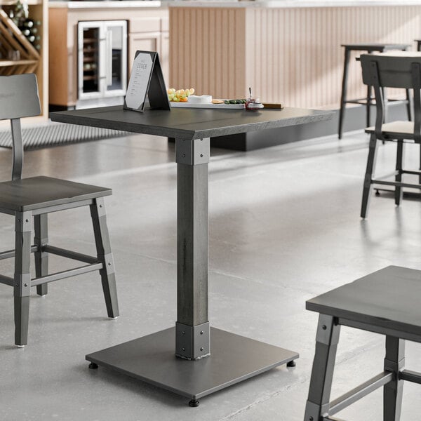 A Lancaster Table & Seating live edge table top with a tablet and food on it.