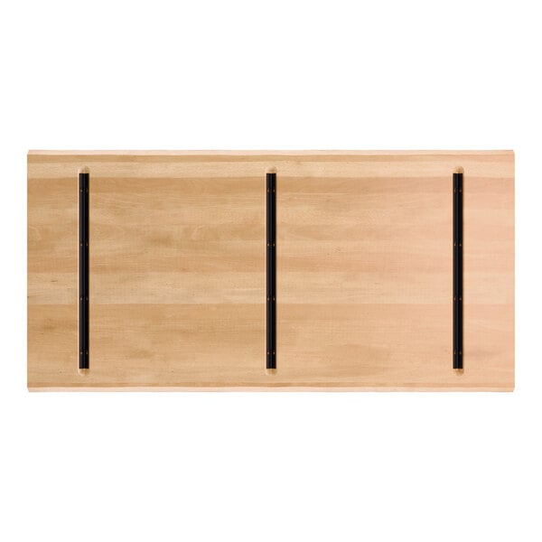 A rectangular wooden tabletop with a honey maple finish, featuring three parallel black metal support bars on the underside.