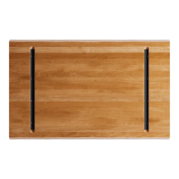 A Lancaster Table & Seating solid wood live edge table top with a honey maple finish.