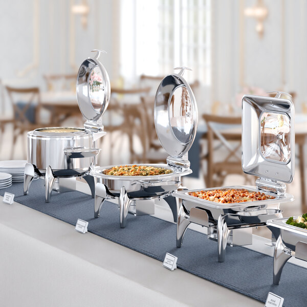 An Acopa stainless steel chafer with food on a table.