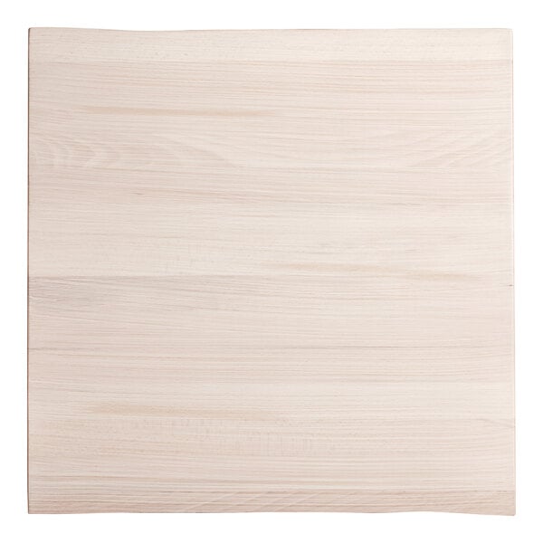 A white square wood surface with a live edge and wood grain.