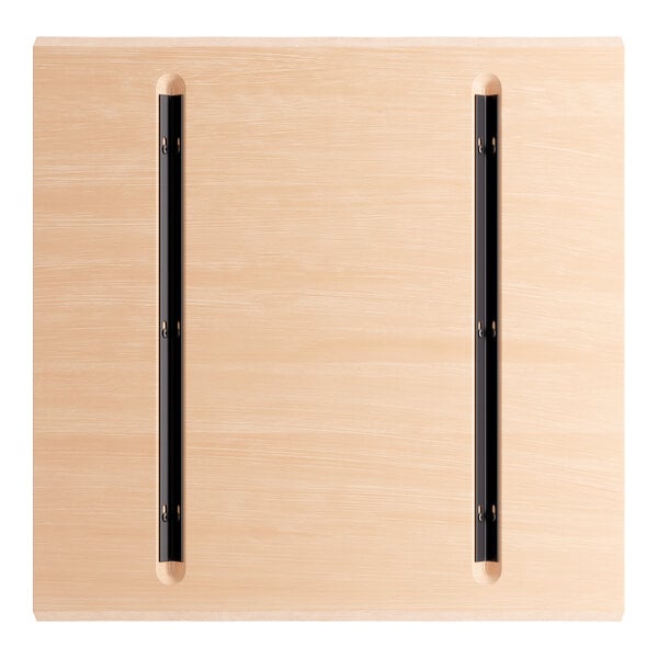 A Lancaster Table & Seating solid wood live edge table top with a bleached oak finish.