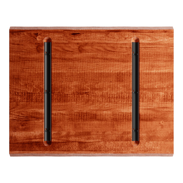 A Lancaster Table & Seating live edge wood table top with black metal hinges.