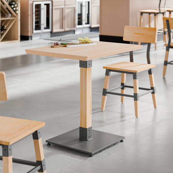 A table and chairs with a Lancaster Table & Seating Solid Wood Live Edge Table Top in a restaurant.