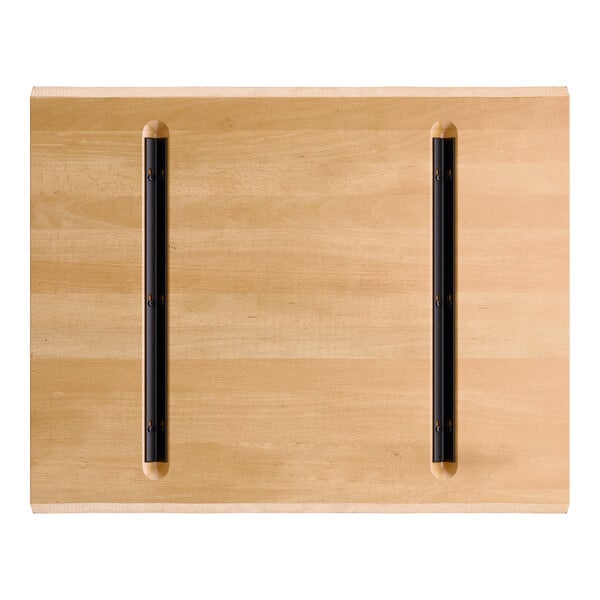 A rectangular wooden tabletop with a light honey maple finish and two parallel black metal support bars attached to the underside.