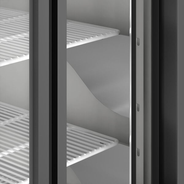 An Avantco stainless steel deli case with curved glass over shelves.
