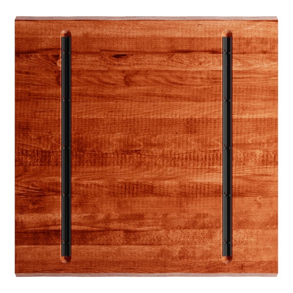 A Lancaster Table & Seating live edge wood table top with black metal rods.