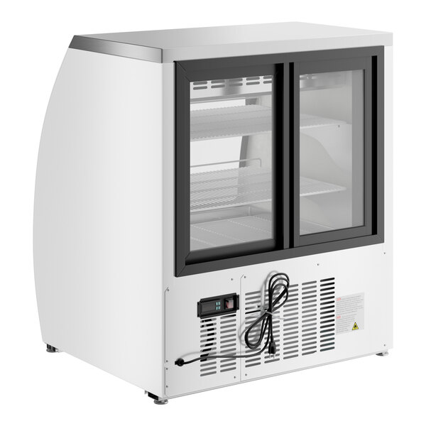 An Avantco white refrigerated deli case with curved glass doors.