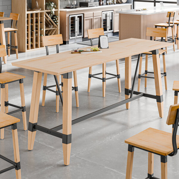 A rectangular solid wood live edge table with a bleached oak finish and industrial metal supports.