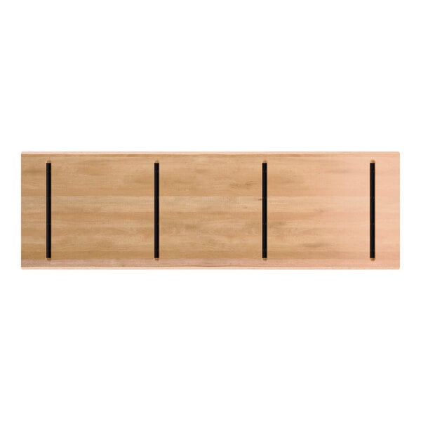 A rectangular wooden tabletop with a honey maple finish, featuring four evenly spaced black lines running parallel to the shorter sides.