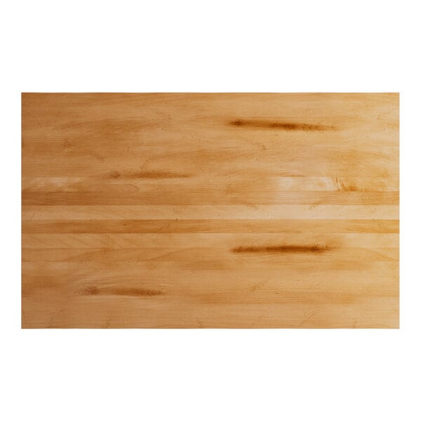 A rectangular solid wood bar height table top with a honey maple finish and live edge design.