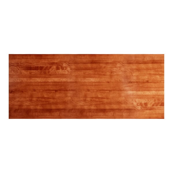 A rectangular solid wood table top with a rustic mahogany finish and live edge design.