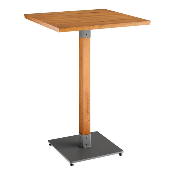 A Lancaster Table & Seating wooden table with a metal base.