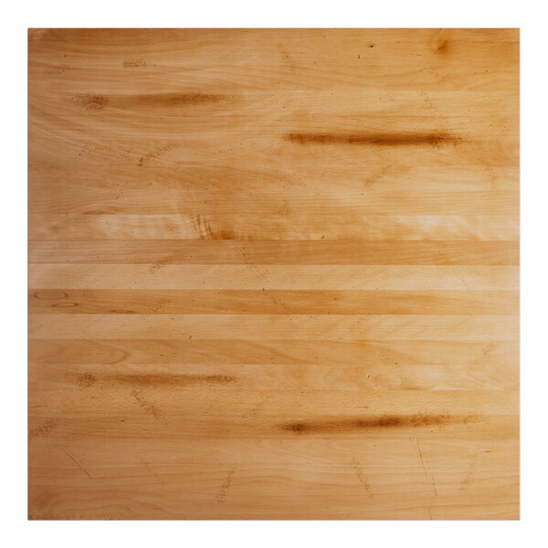 A square solid wood bar height table top with a honey maple finish and live edge design.