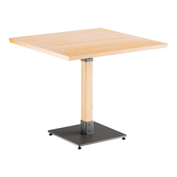 A Lancaster Table & Seating square table with a metal base and wooden top.