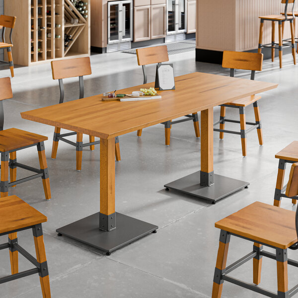 A Lancaster Table & Seating live edge wood table with chairs in a room.