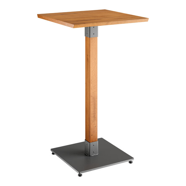 A Lancaster Table & Seating bar height table with a wooden square top and metal base.