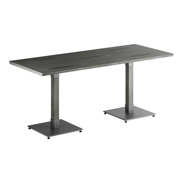 A rectangular table with a solid wood top and two metal pedestal legs, featuring a slate gray finish.