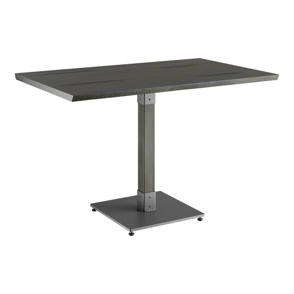 A Lancaster Table & Seating rectangular table with a metal base.