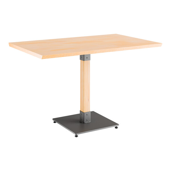 A Lancaster Table & Seating solid wood table with a live edge and metal base with a black finish.
