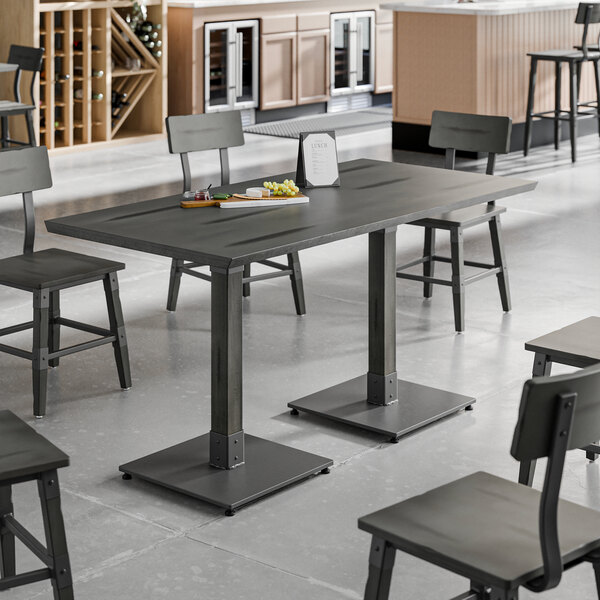 A Lancaster Table and Seating solid wood table with chairs in a room.