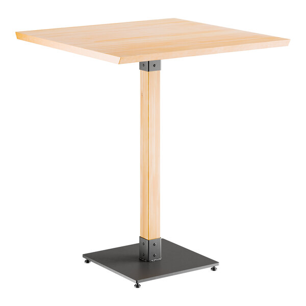 A Lancaster Table & Seating bar height table with a square wooden live edge top and metal base.