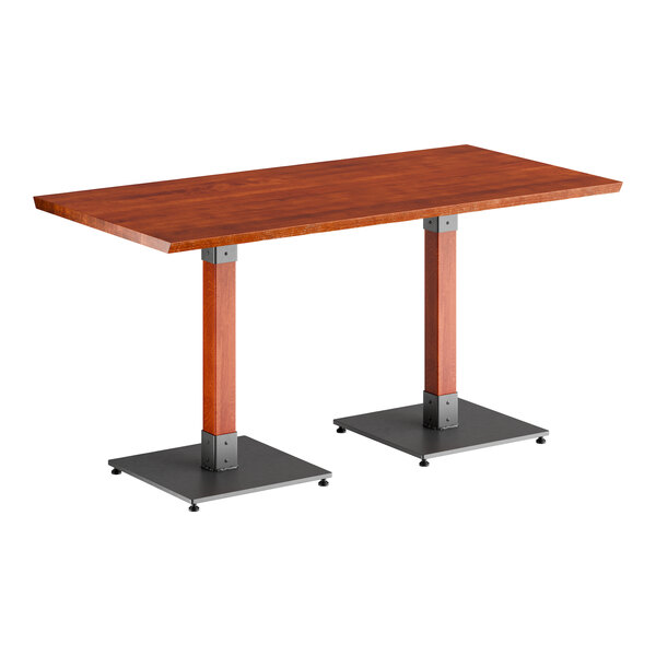 A Lancaster Table & Seating live edge wood table with a metal base.