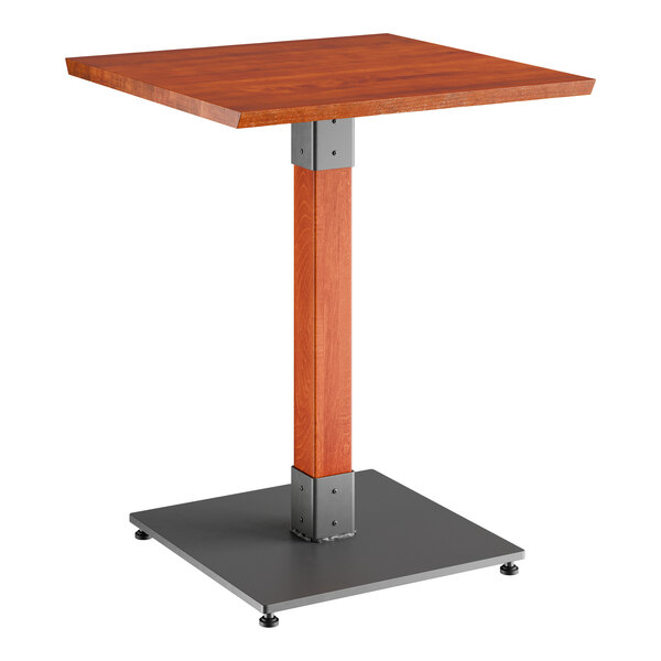 A Lancaster Table & Seating wooden table with a metal base.