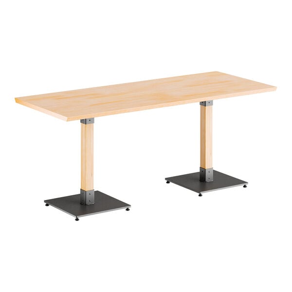 A Lancaster Table & Seating live edge table with metal legs.