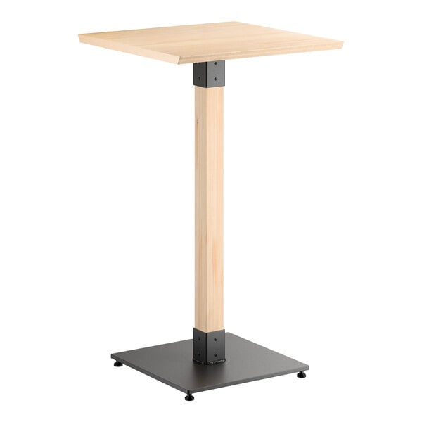 A square bar-height table with a light wood top and central wooden support, featuring a black metal base and metal accents at the joints.