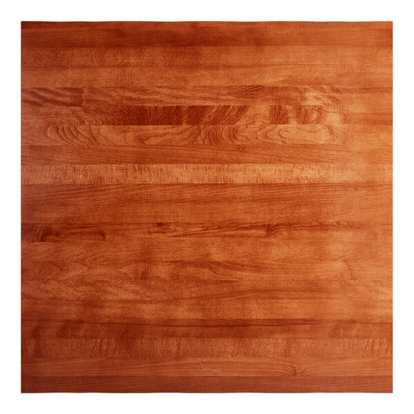 A square solid wood table top with a rustic mahogany finish and a live edge design.