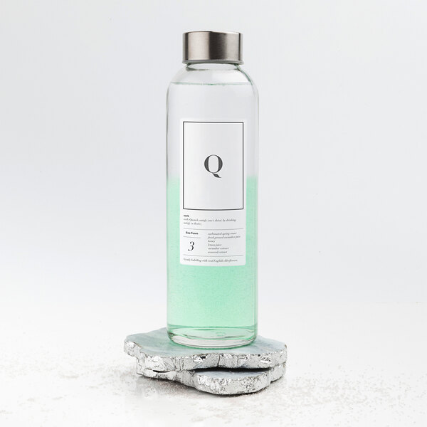 A white water bottle with a black and white Avery shipping label on a counter.