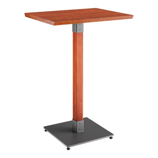 A Lancaster Table & Seating live edge bar height table with a wooden top and metal base.
