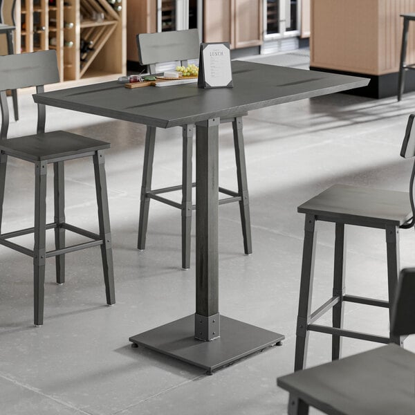 A Lancaster Table & Seating live edge table with a slate gray finish.