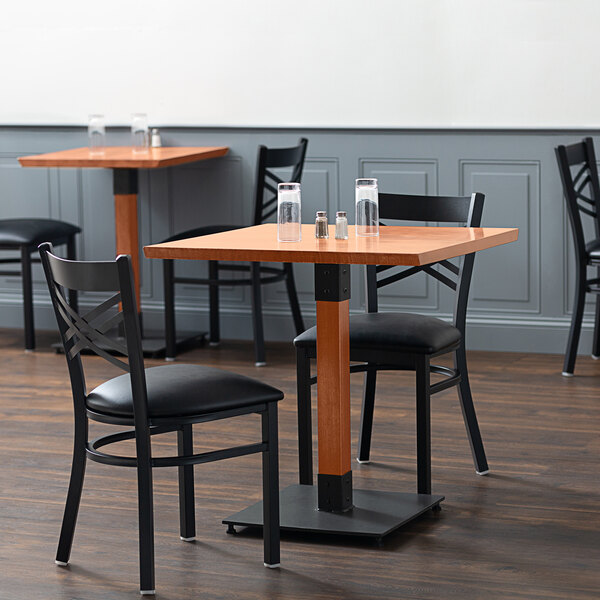 A Lancaster Table & Seating live edge wood table and chairs in a restaurant dining area.