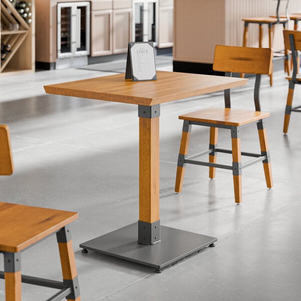 A Lancaster Table & Seating live edge wood table with chairs in a restaurant.