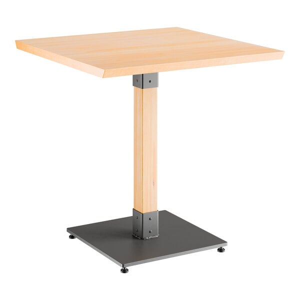A Lancaster Table & Seating square table with a metal base and wooden top.