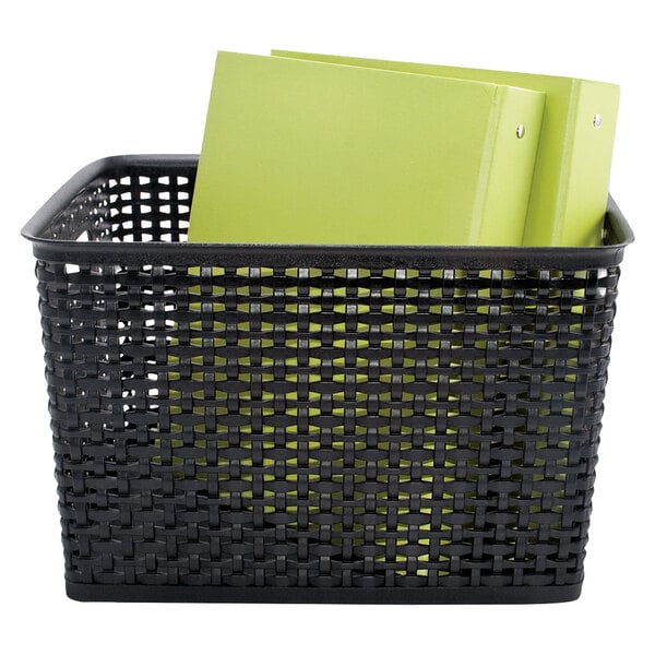 A black plastic weave bin with green folders inside.