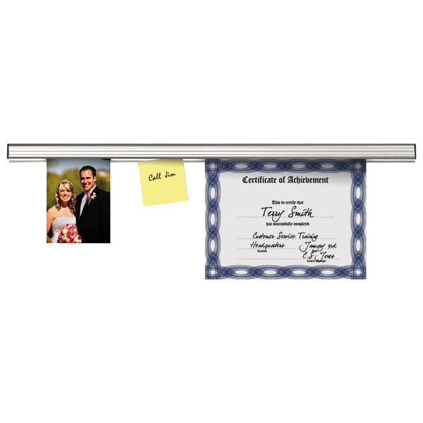 An Advantus aluminum display rail holding a certificate and post-it notes.