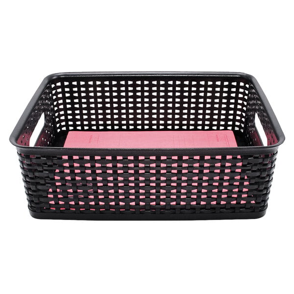 a black basket with a pink book inside