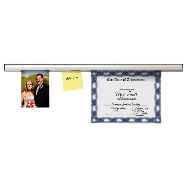 An Advantus aluminum display rail holding a certificate and a picture of a couple.