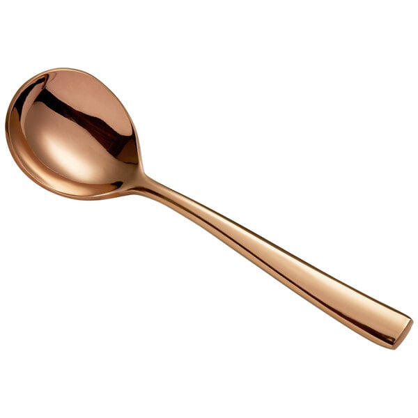 A close-up of a Bon Chef rose gold stainless steel bouillon spoon.