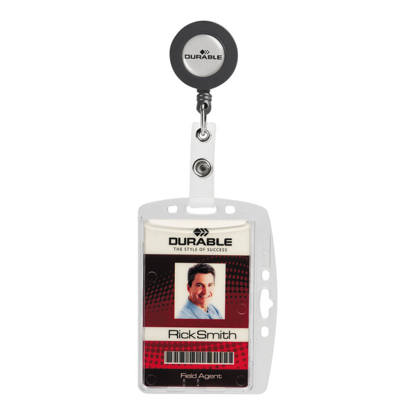 A clear acrylic badge holder with a retractable badge reel, displaying an identification card with a photo and text.