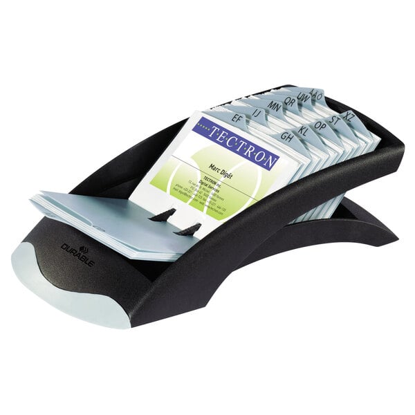 A black and grey Durable VISIFIX business card holder on a counter with business cards inside.