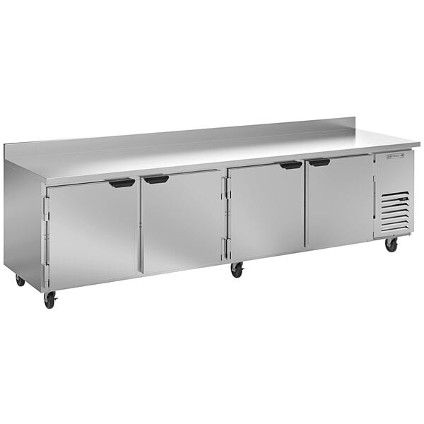 A Beverage-Air stainless steel worktop refrigerator with three doors.