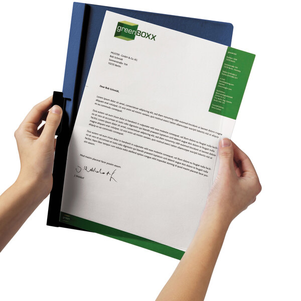 A person's hands holding a Durable dark blue and clear report cover with a document inside.